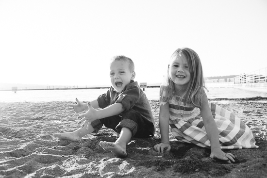 siblings playing in the sand