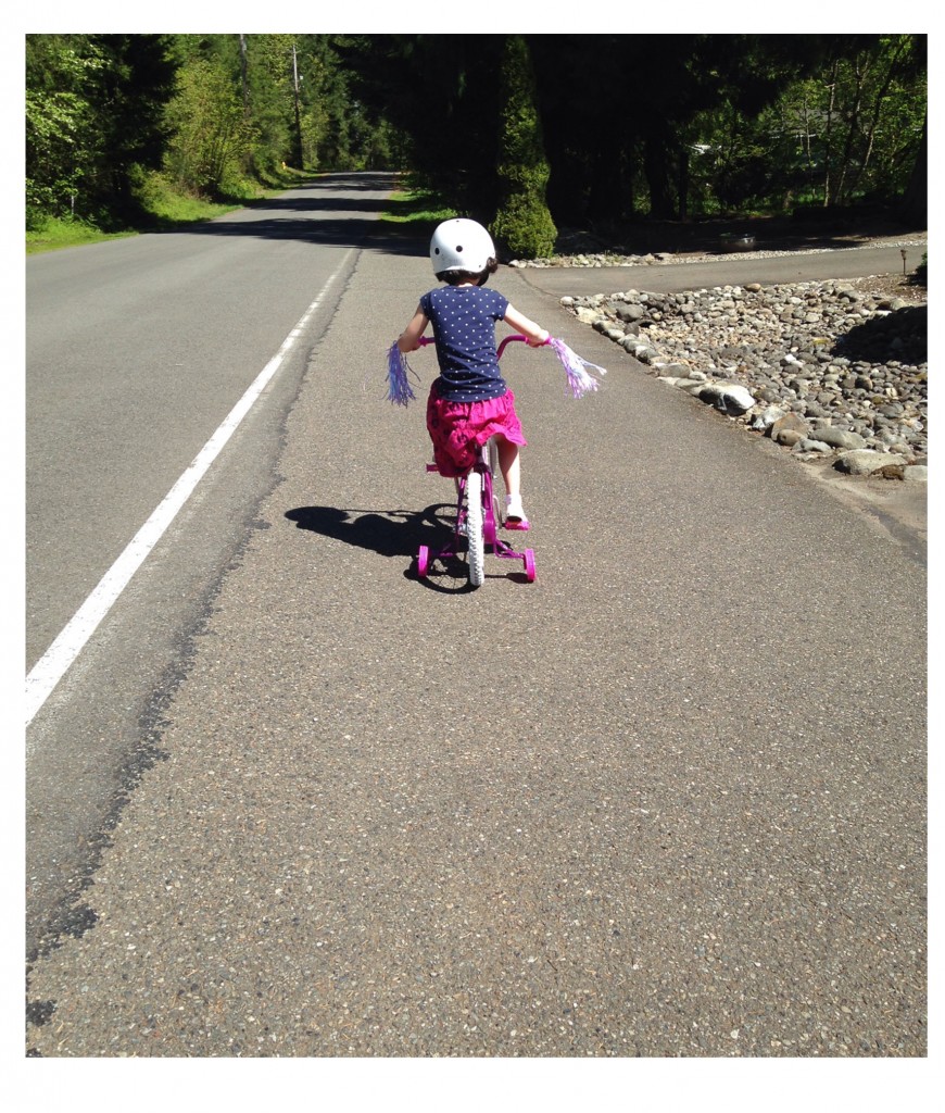 young girl rides big bike